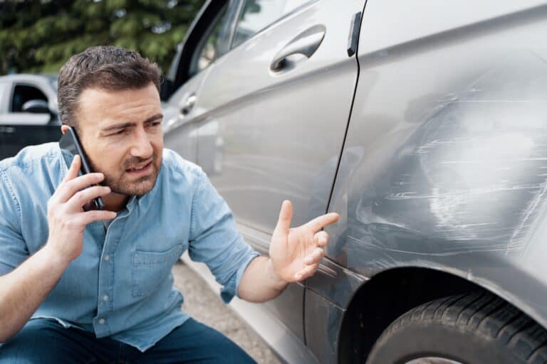 One man reporting car damage calling insurance service